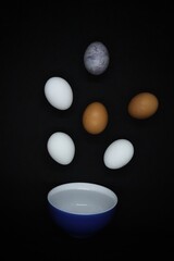
Chicken eggs fly into a blue plate