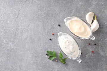 Garlic sauce and ingredients on gray textured background
