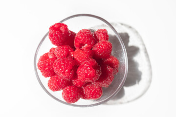 Fresh and ripe raspberries on a white background with copy space