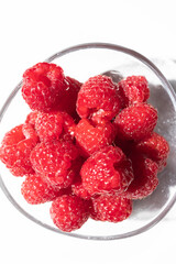 Fresh and ripe raspberries on a white background with copy space