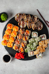 Japanese rolls on a platter, with wasabi, ginger and soy sauce