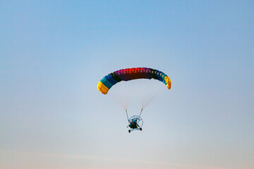 Paragliding on a blue sky. Sport in which the players fly in the air using paragliders