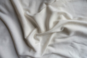 Rumpled white cotton and polyester ribbed fabric