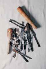 old rusty cutlery: knives, forks, teaspoons, corkscrew, nutcracker