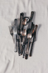 old rusty cutlery: knives, forks, teaspoons, corkscrew, nutcracker