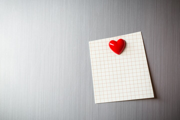 Abstract of wooden heart clip with Blank paper and stick paper on refrigerator door. paper note...