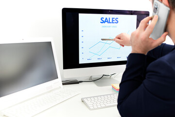 young man at work explaining marketing charts to support his business team
