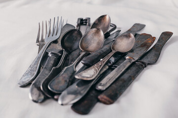 old rusty cutlery: knives, forks, teaspoons, nutcracker