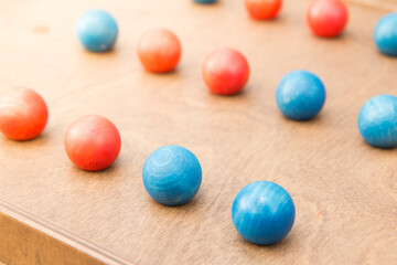 Fototapeta na wymiar Mind game with colorful wooden balls close up