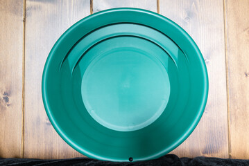 Gold pan. Green plate for finding nuggets or flakes of gold in rivers and streams. Gold panning...