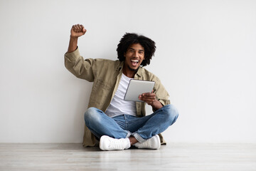 Online Win. Joyful Black Male Celebrating Success With Digital Tablet © Prostock-studio