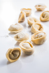 Raw fresh dumplings , or italian tortellini pasta, isolated on white background