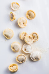 Raw fresh dumplings , or italian tortellini pasta, isolated on white background