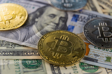 bitcoin coins lie on dollars close-up