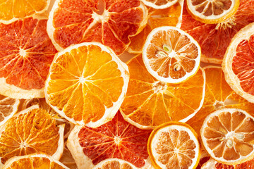 Texture of citrus. Dried slices of oranges, lemons, grapefruits. Bright background.