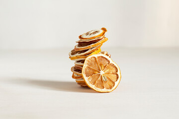 Tower of slices of dried lemons on a white background