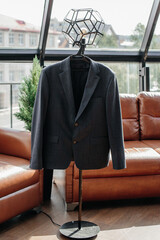 Wedding suit on a hanger in the middle of the room close-up