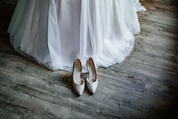 White wedding shoes standing near the bride
