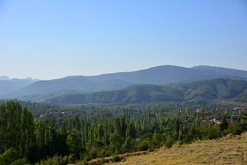 mountain range with forest line on blue sky background, Turkey