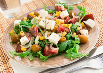 fresh vegetarian healthy vegetable salad with arugula and chees
