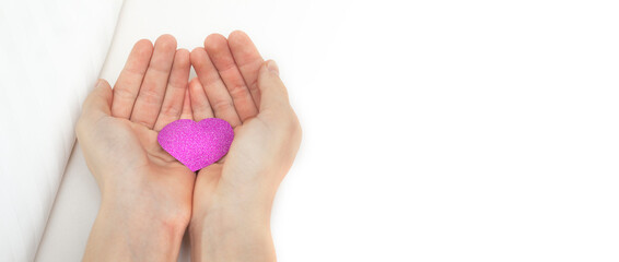 Rose petals in the hands on a white background. Heart in hand on Valentine's Day.