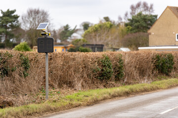Solar powered speed trap that has built in number plate recognition to catch and prosecute people speeding through a countryside village