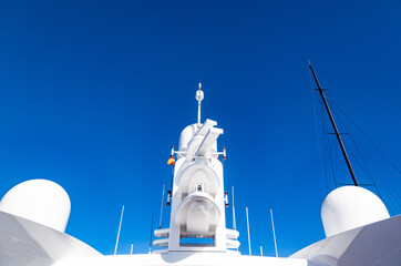 Large mast of a yacht with navigational equipment, view from below. Radars, signal lights,...