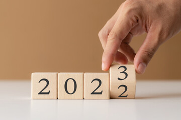 2023 new year goal planning idea, wood block cube with new year 2023 and target icon, business...