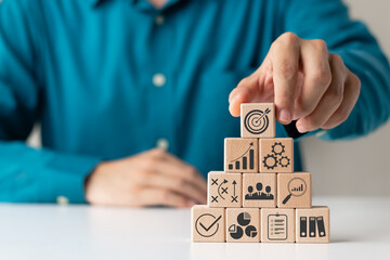 hand woods block cube with icon company strategy development, Concept success and business goals.