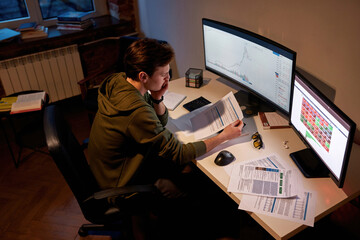 Top view of male trader looking at data document
