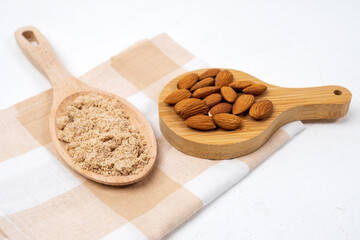 Alternative nut flour made of almond nuts, light background.