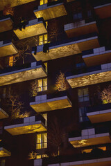 cozy balconies of modern responsible architecture with plants full grown trees and landscaping at pink dusk