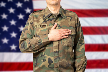 An American soldier man pledging allegiance in front of his country's flag