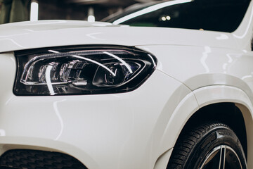 Fototapeta premium Close up white car head lights