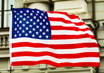 USA, United States, American flag waving in the city with government buildings on background