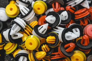 Macro photography of plastic multi-colored clips for a car. Car clips, plastic fasteners, colorful...