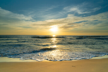 Fototapeta na wymiar Beautiful beach sunset Water wave on sandy beach