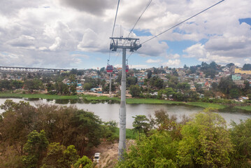 Obraz premium View of the poorest neighborhoods of Santo Domingo on the banks of Ozama river from teleferico cable car, slum and poverty of the capital city of Dominican Republic, Caribbean