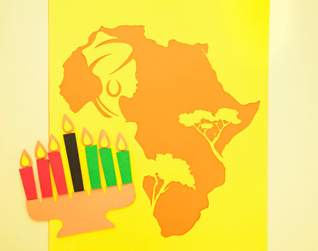 Silhouette Of The African Continent With Trees And The Head Of A Woman In A Turban And With Earrings. Background For Black History Month Or Happy Kwanzaa