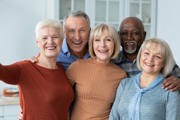 Positive senior people taking selfie together, kitchen interior - Powered by Adobe