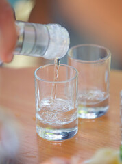 Pour the alcoholic beverage vodka into a glass.