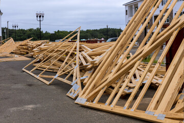 Stacked wooden timber for trusses for roof near construction site