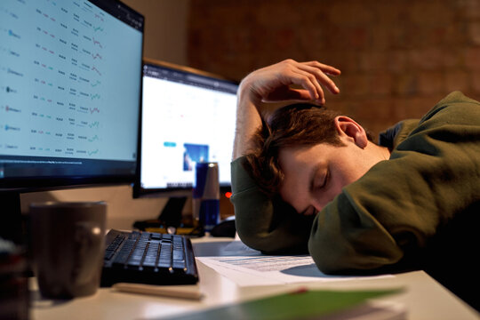 Tired male trader or broker sleeping at table