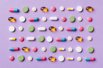 Many different pills and space for text on colorful background, top view. Different pills on color background, flat lay