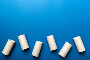 Flat lay composition with empty toilet paper rolls and space for text on color background. Recyclable paper tube with metal plug end made of kraft paper or cardboard