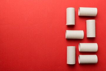Flat lay composition with empty toilet paper rolls and space for text on color background. Recyclable paper tube with metal plug end made of kraft paper or cardboard