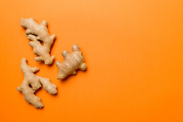 Finely dry Ginger powder in bowl with green leaves isolated on colored background. top view flat lay