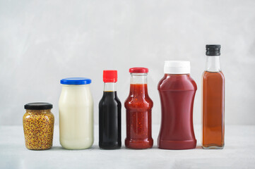 A set of different sauces on the table, gray background - Powered by Adobe
