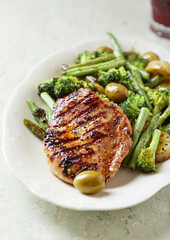 Grilled Turkey Breast with oven baked potatoes and broccoli. Close up. 