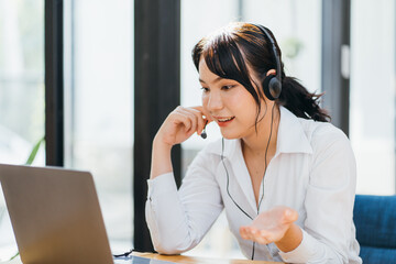 Young friendly operator woman agent with headsets working in a call centre.